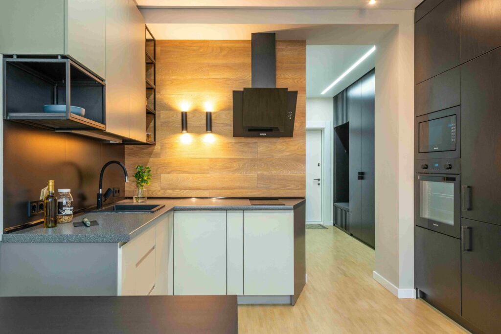 A sleek modern kitchen featuring contrasting black and white cabinets, showcasing a stylish and contemporary design.